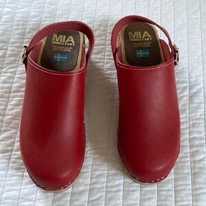 Mia wooden and leather clogs. Stamped size 41. Fits a women’s size 9.